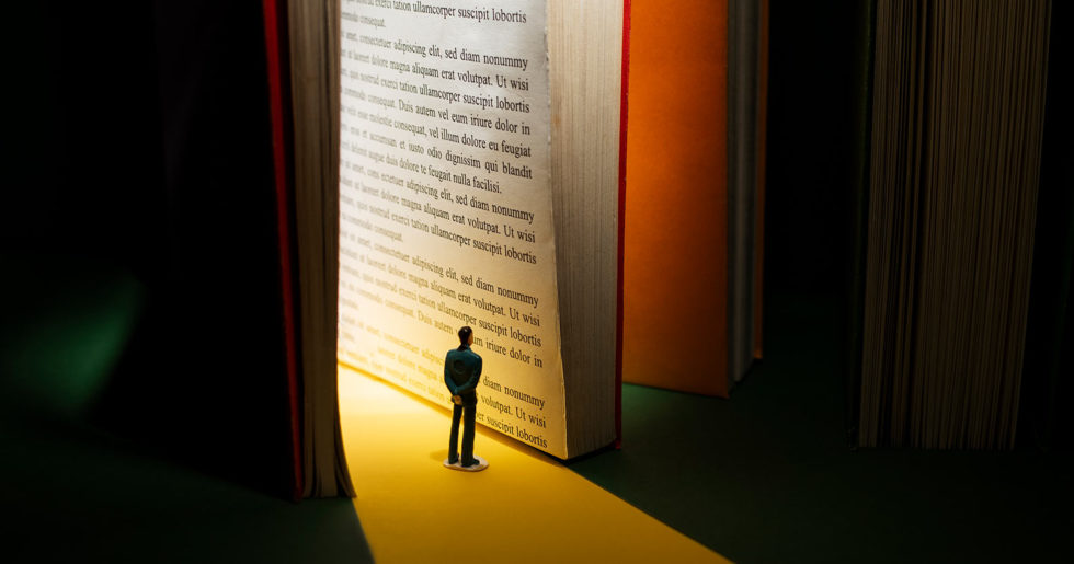 Illustration of a man reading a giant book