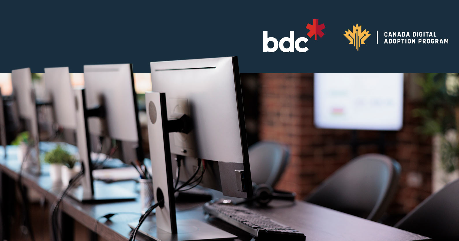 Photo of computers with a BDC Loan logo on top